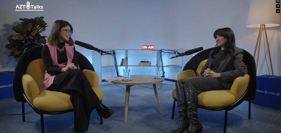 Two guests on the set with the On Air sign