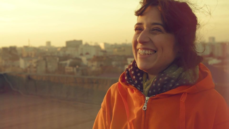 Young woman smiling on a terrace in Bucharest